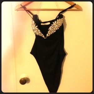 Sparkle onesie with adjustable straps.